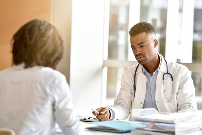 Woman at doctor's office for sciatica surgery