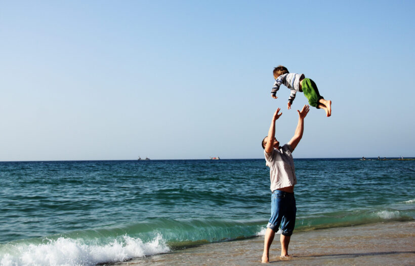 Happy father and son on the beach