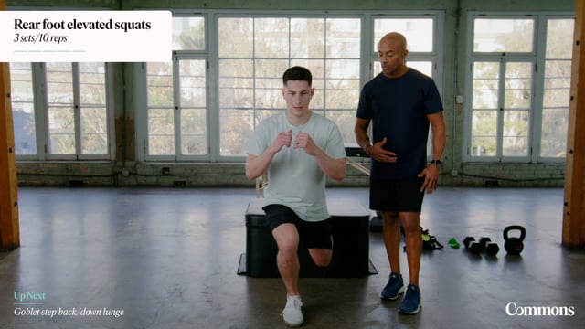 Patient in gym performing lunges while an instructor looks on